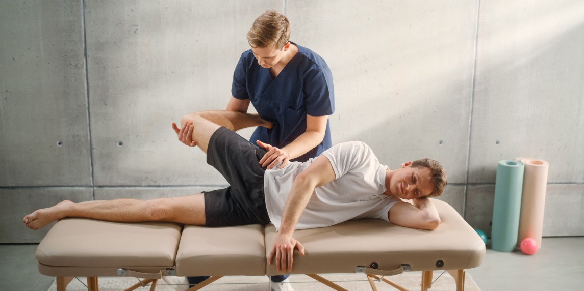 Sportsman Patient Undergoing Physical Therapy to Recover from Surgery and Increase Mobility. Physiotherapist Works on Specific Muscle Groups or Joints to Rehabilitate from Severe Injury.