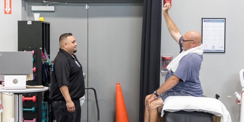 physical therapy for scoliosis. XO expert in physiotherapy during his work with a patient: doing exercises