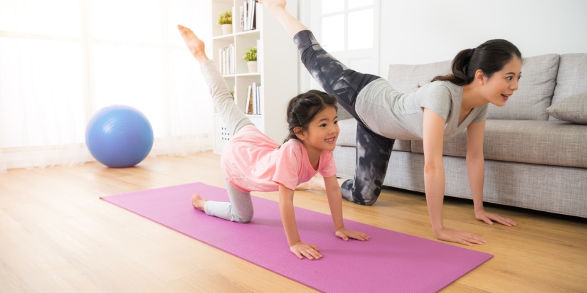 asian pretty mother and her youth kid daughter in the gym center doing stretching fitness exercise yoga together, parent accompany children sport concept.