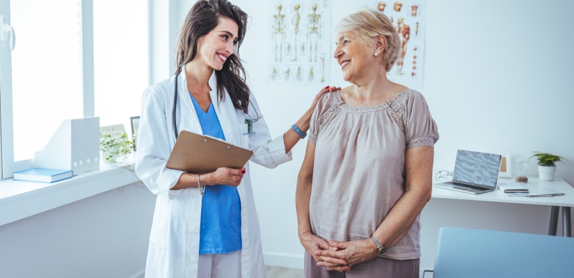 Doctor and patient discussing something at hospital . Medicine and health care concept. Doctor and patient. Patient Having Consultation With Doctor In Office.