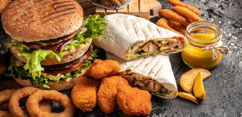 Close-up of home made tasty burger and hot dogs with fried chicken french fries. raditional American food. fast food.