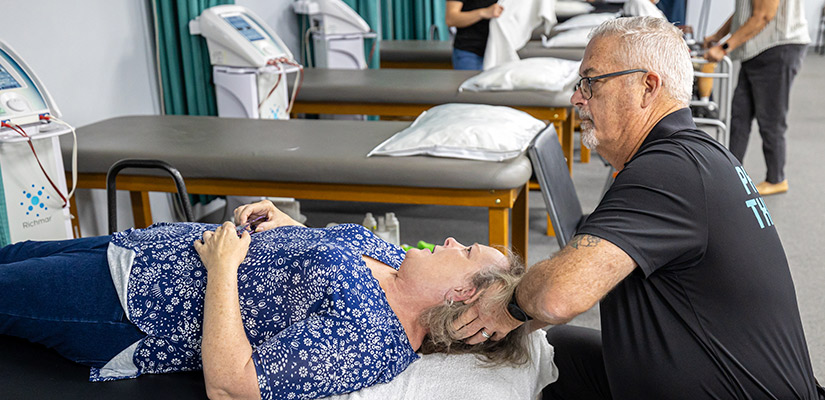 XO Therapy. Woman receiving deep tissue neck massage.