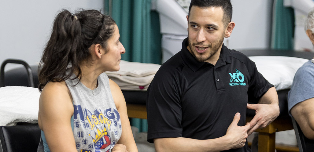 XO Physiotherapy talking with patient. therapy joint mobilization